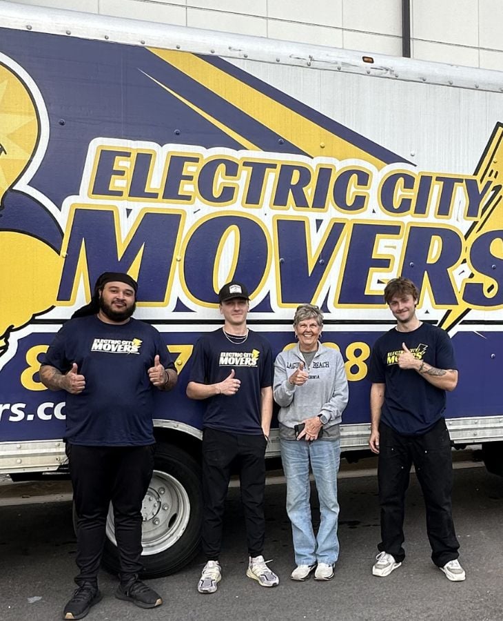 Three Electric City Movers LLC crew members and a satisfied customer giving thumbs up in front of a branded moving truck in Anderson, SC